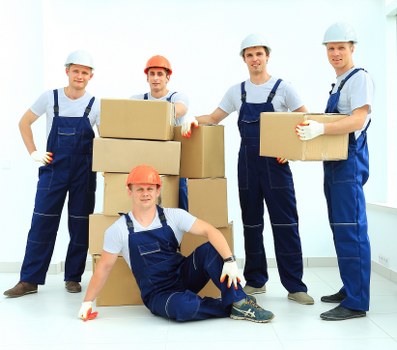 Local moving team carefully packing household items