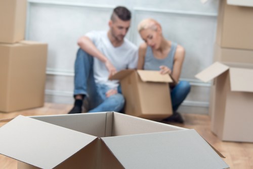 Household items prepared for transport by a moving van team
