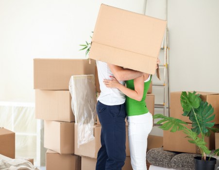 Loading furniture into a moving truck on a residential street
