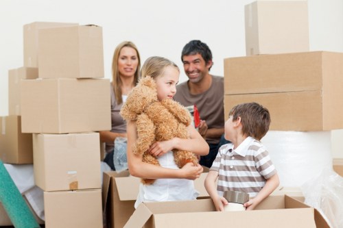 Movers carrying household furniture through a home in Old Coulsdon